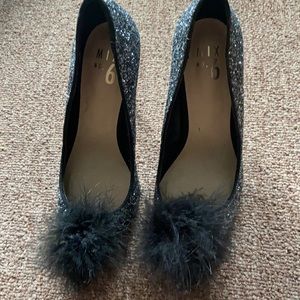 Sparkly black heels with pop Pom front
